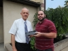 RPHS teacher Raymond Bangs stands with RPHS alumni Bobby Repousis holding an interface which improves graphing calculator capabilities.
